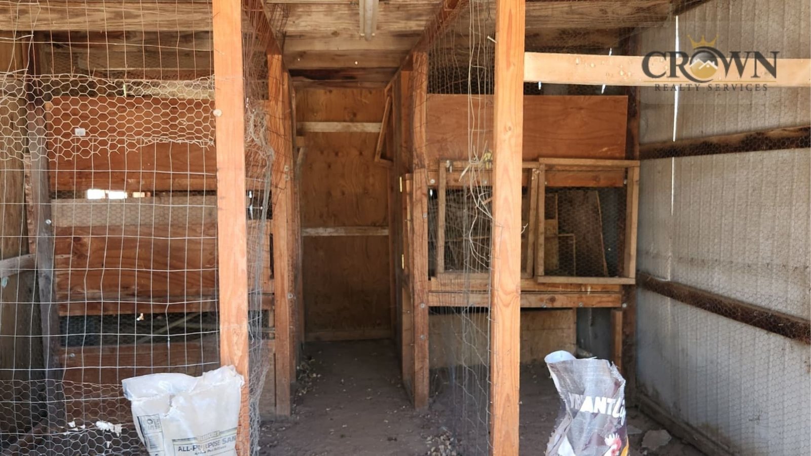 Large wooden poultry coops and chicken runs installed on the ranch lot in Phelan, CA.