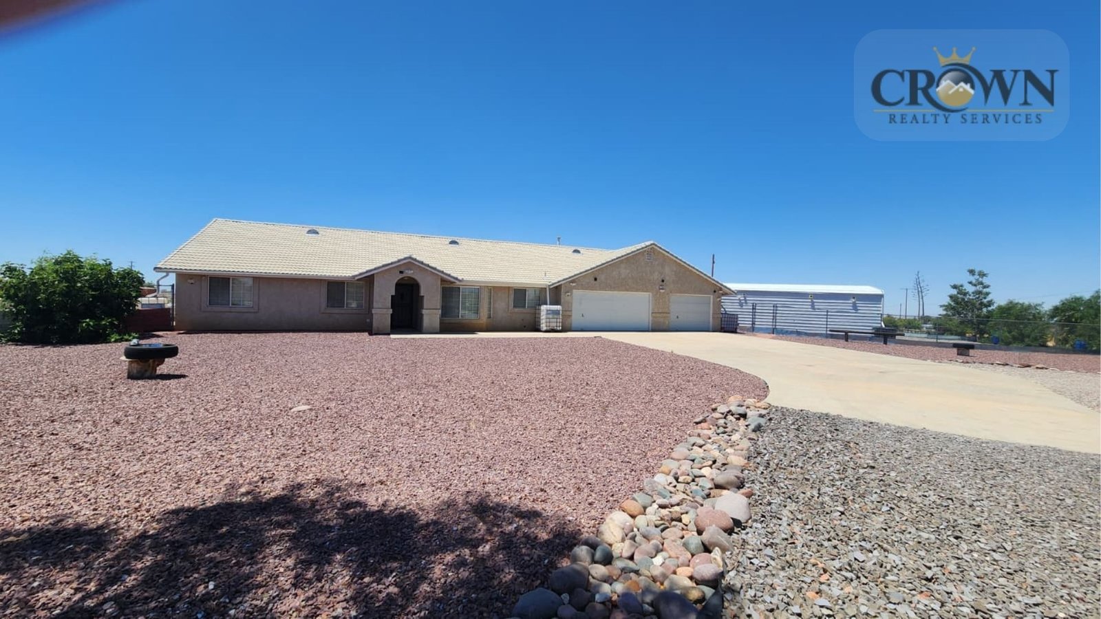 Front exterior facade of a ranch-style 3-bedroom home for sale in Phelan, California.