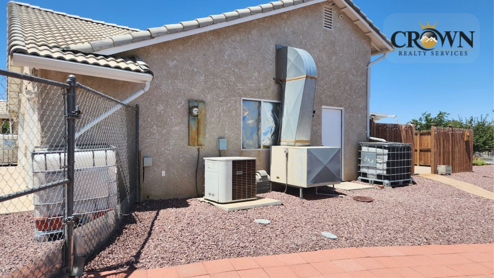 High-efficiency HVAC air conditioning units installed on the exterior of the Phelan ranch house.