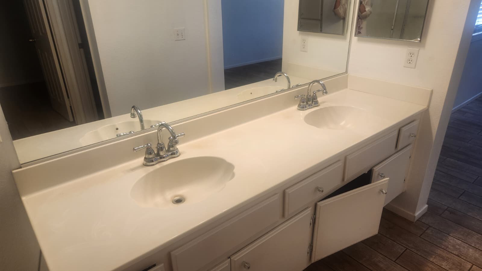 Vanity and mirror area in bathroom of home for sale in Victorville by Crown Realty Services