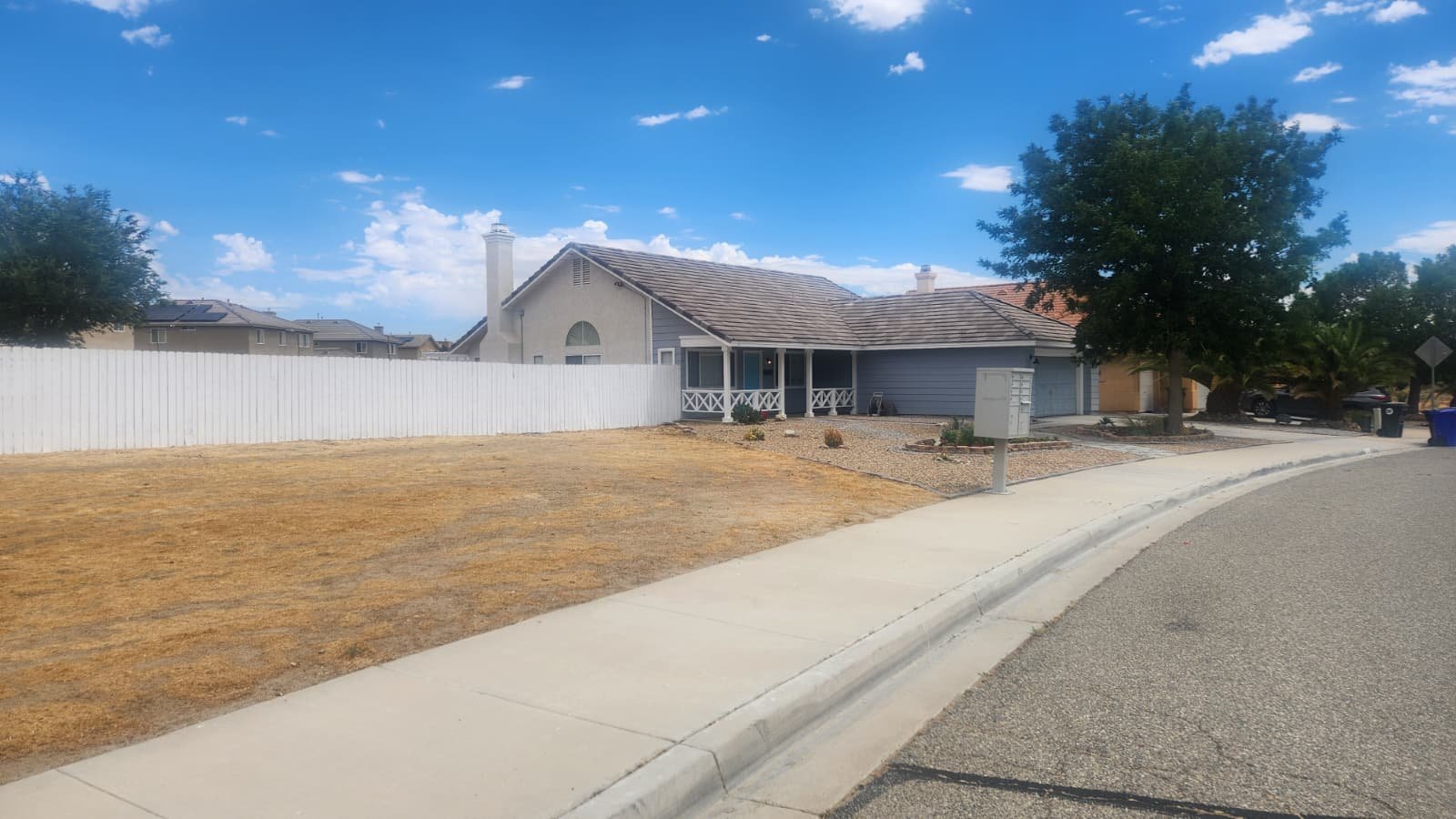 Outside view of 4-bedroom home for sale in Victorville CA with a front view by Crown Realty Services